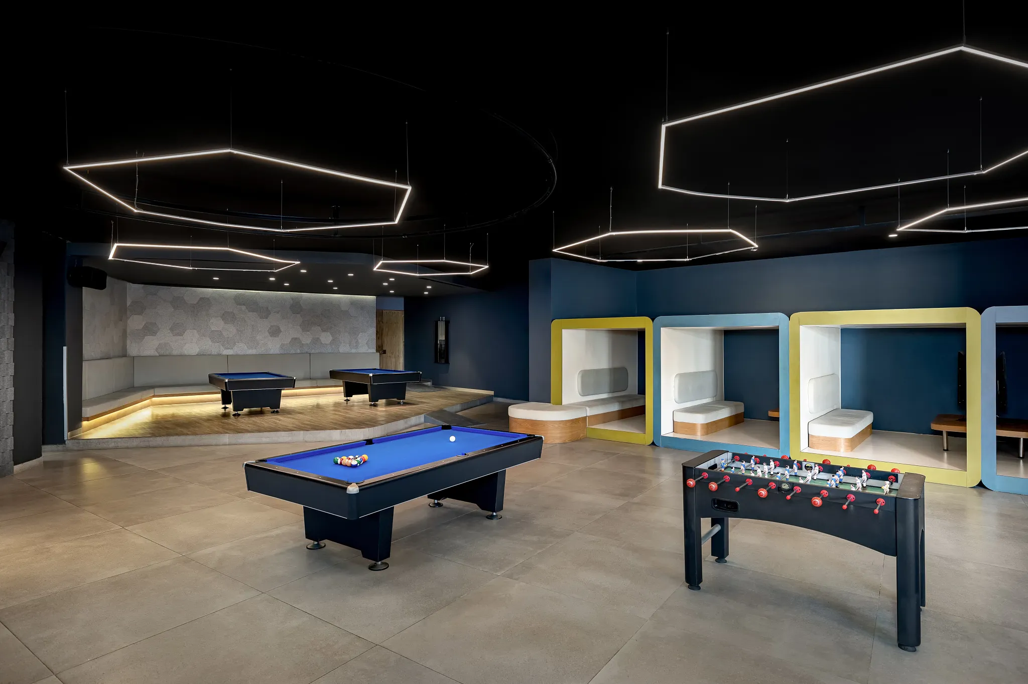 Teen game room with pool tables, foosball, and modern lounge seating at Dreams Bahia Mita.