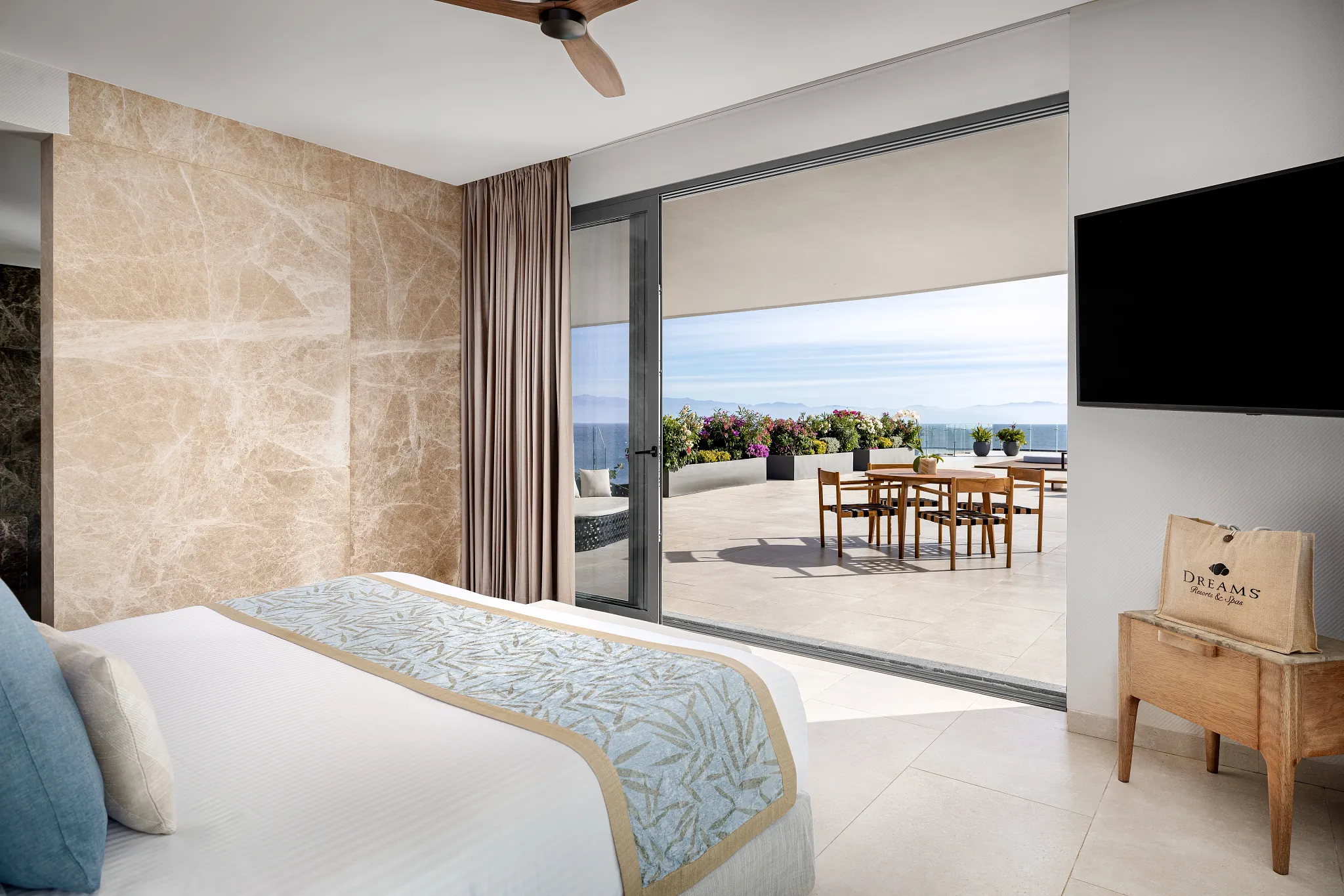 Presidential Suite king bedroom with terrace access at Dreams Bahia Mita Resort.