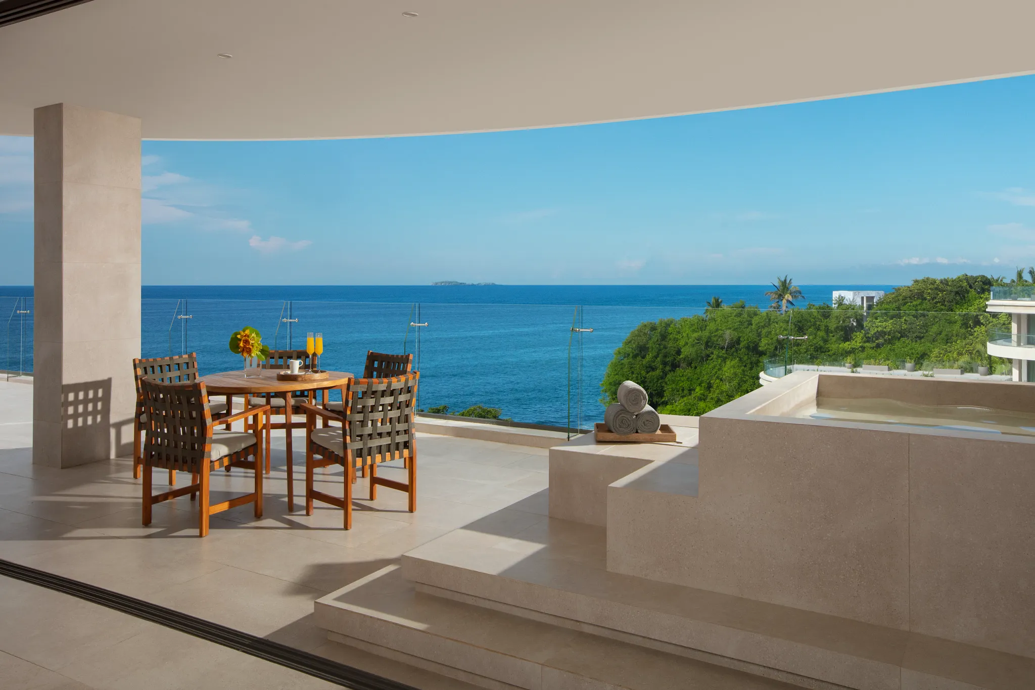Presidential Suite terrace with outdoor soaking tub and dining area overlooking ocean at Dreams Bahia Mita.