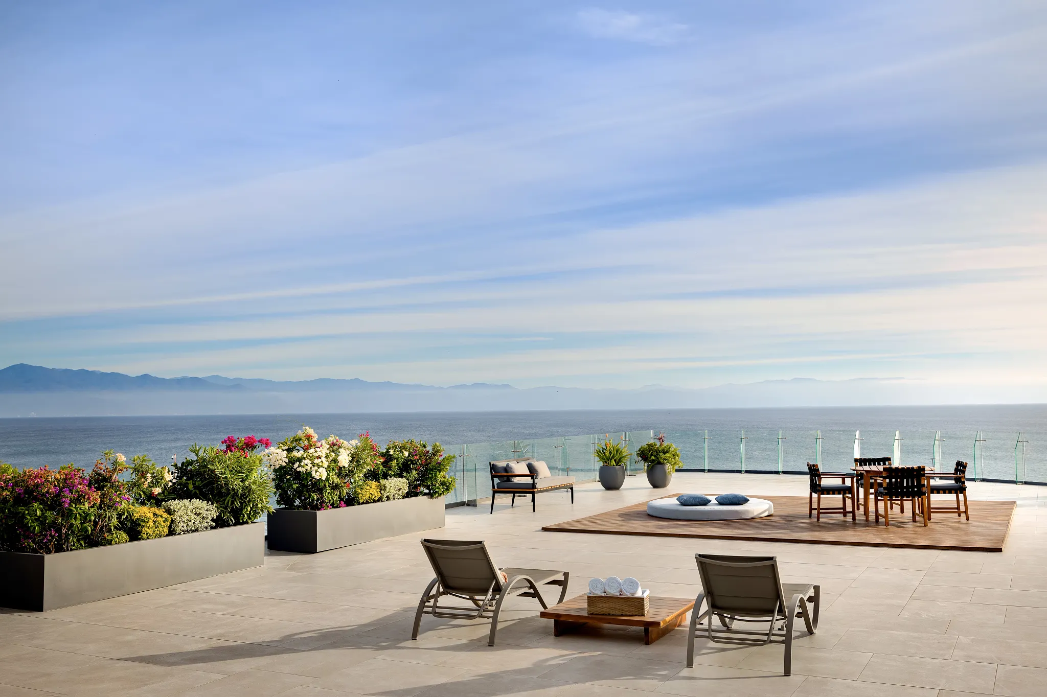 Presidential Suite terrace solarium with loungers and ocean view at Dreams Bahia Mita.