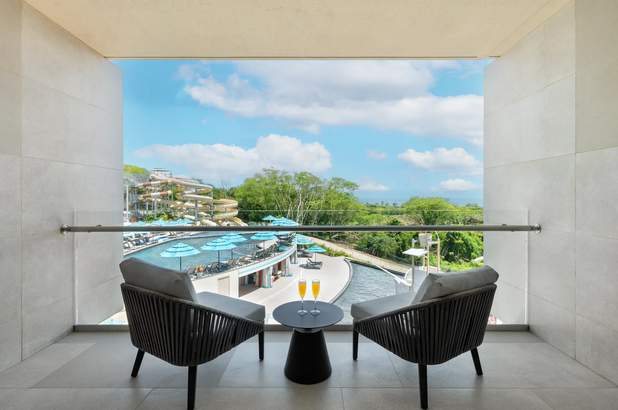 Junior Suite Waterpark View balcony overlooking pools and slides at Dreams Bahia Mita Surf & Spa Resort.