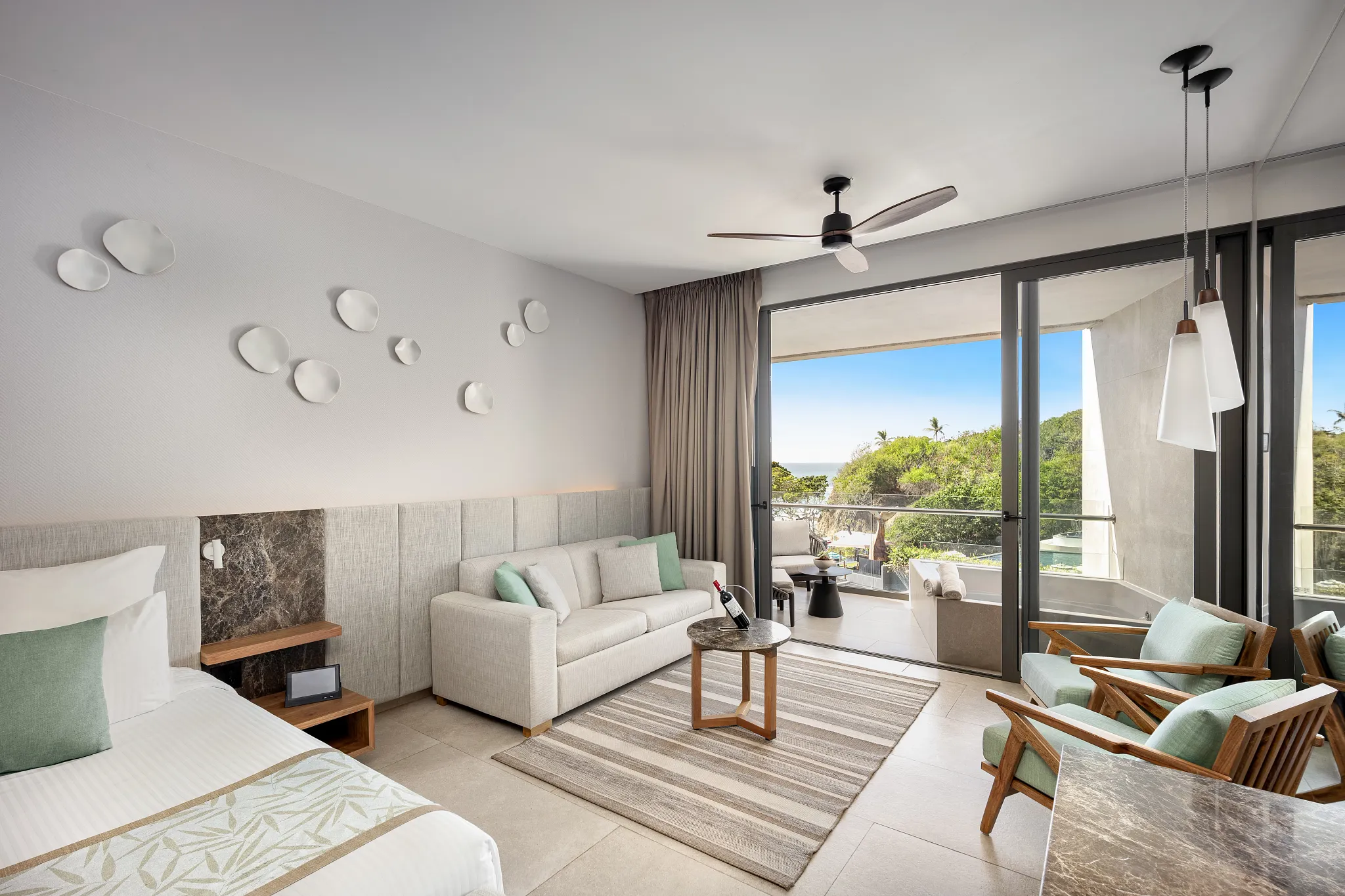 Preferred Club Junior Suite Panoramic View with king bed, sofa seating area, and terrace with outdoor soaking tub at Dreams Bahia Mita Resort.