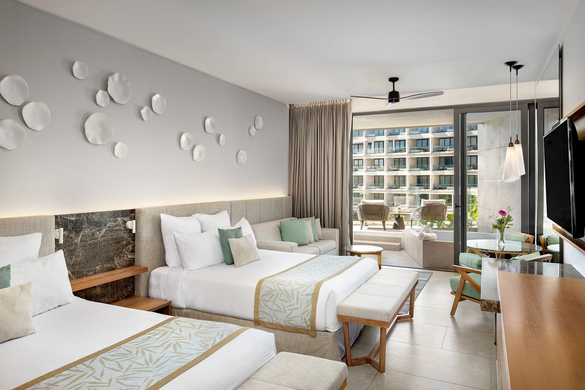 Preferred Club Junior Suite Sun Deck with two queen beds and terrace access at Dreams Bahia Mita Surf & Spa Resort.