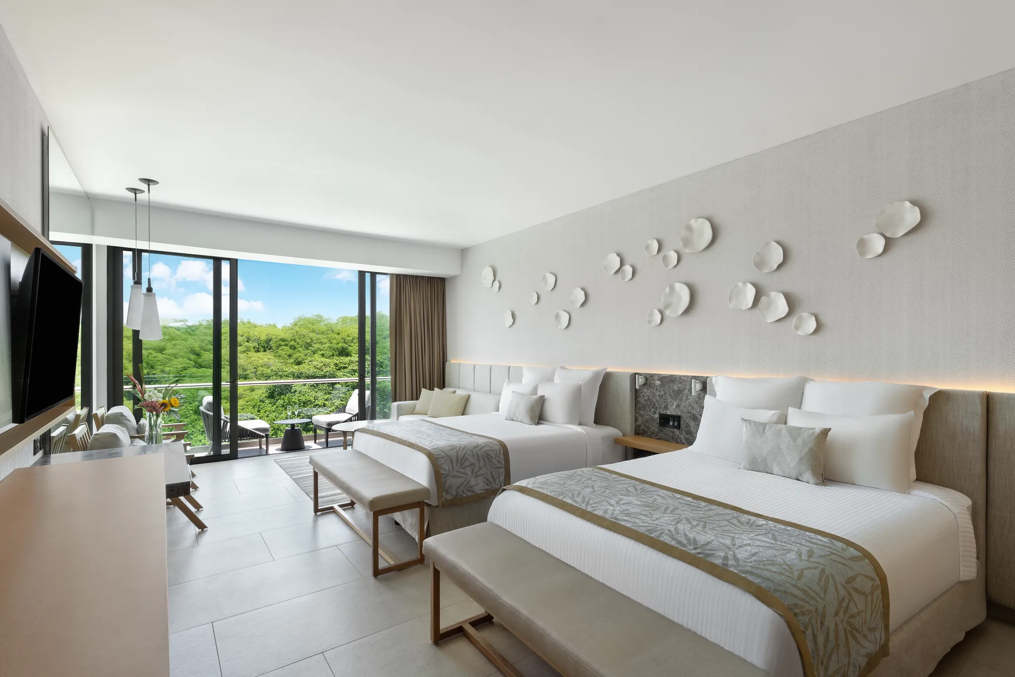 Preferred Club Junior Suite Tropical View with two queen beds and balcony access at Dreams Bahia Mita Resort.