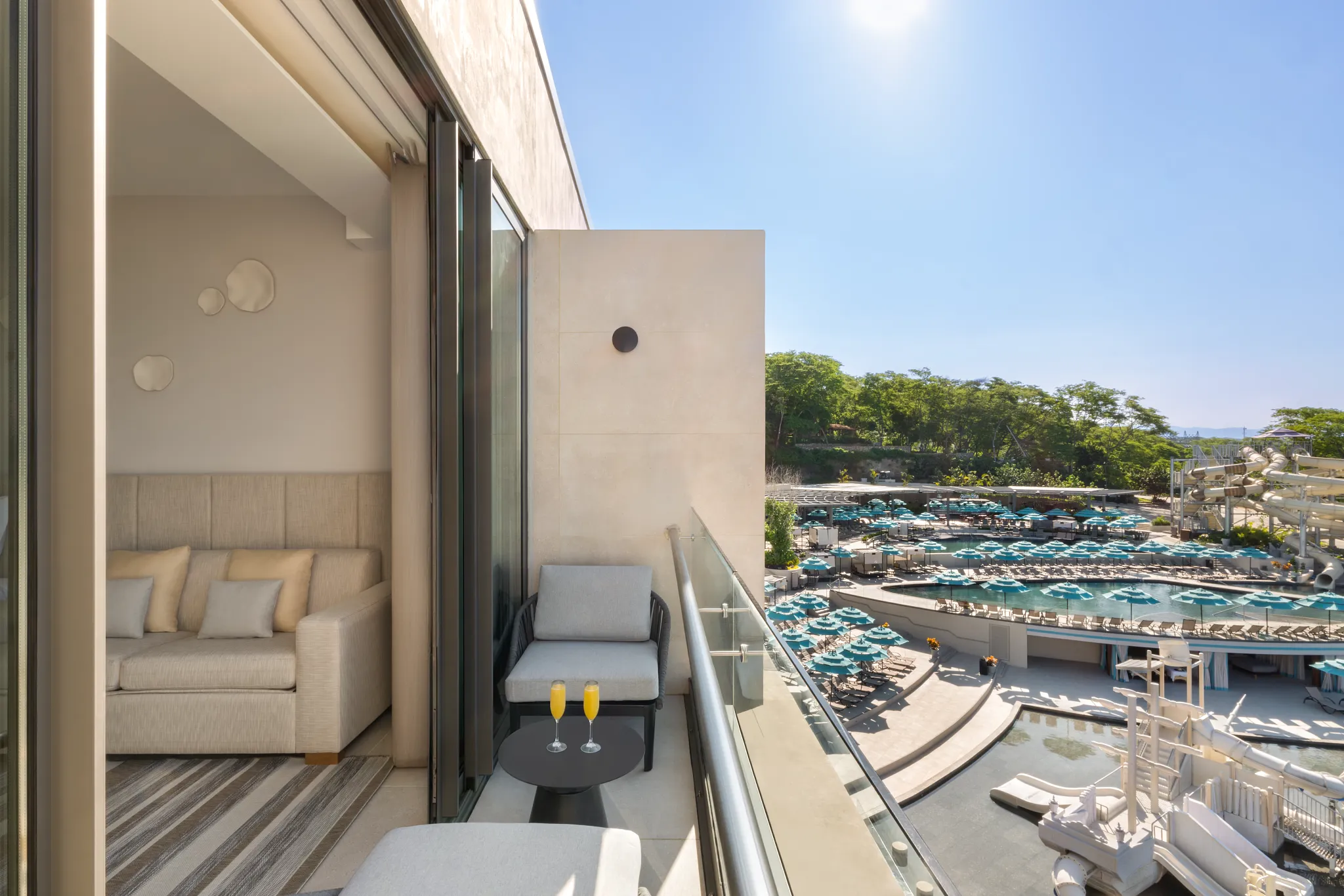 Preferred Club Junior Suite Waterpark View balcony overlooking pools and slides at Dreams Bahia Mita Surf & Spa Resort.