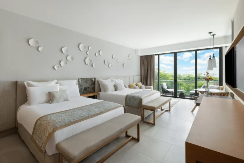 Preferred Club Junior Suite Waterpark View with two queen beds and modern décor at Dreams Bahia Mita Resort.