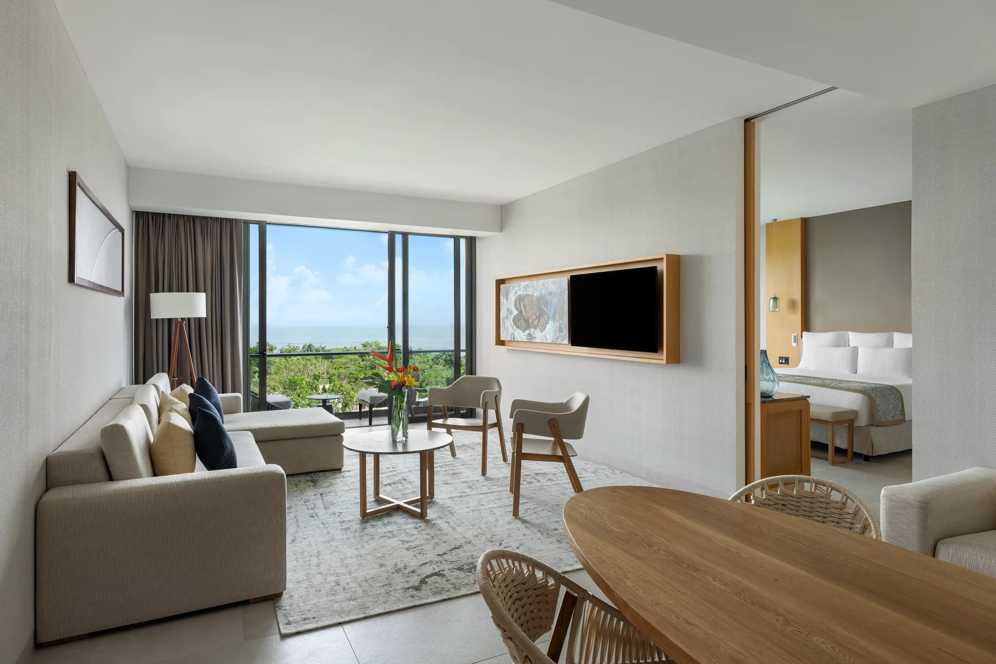 Preferred Club Master Suite living area with sofa and ocean-facing balcony at Dreams Bahia Mita Resort.